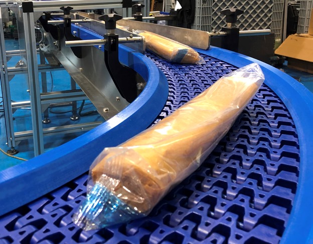 bakery conveyor with french sticks of bread